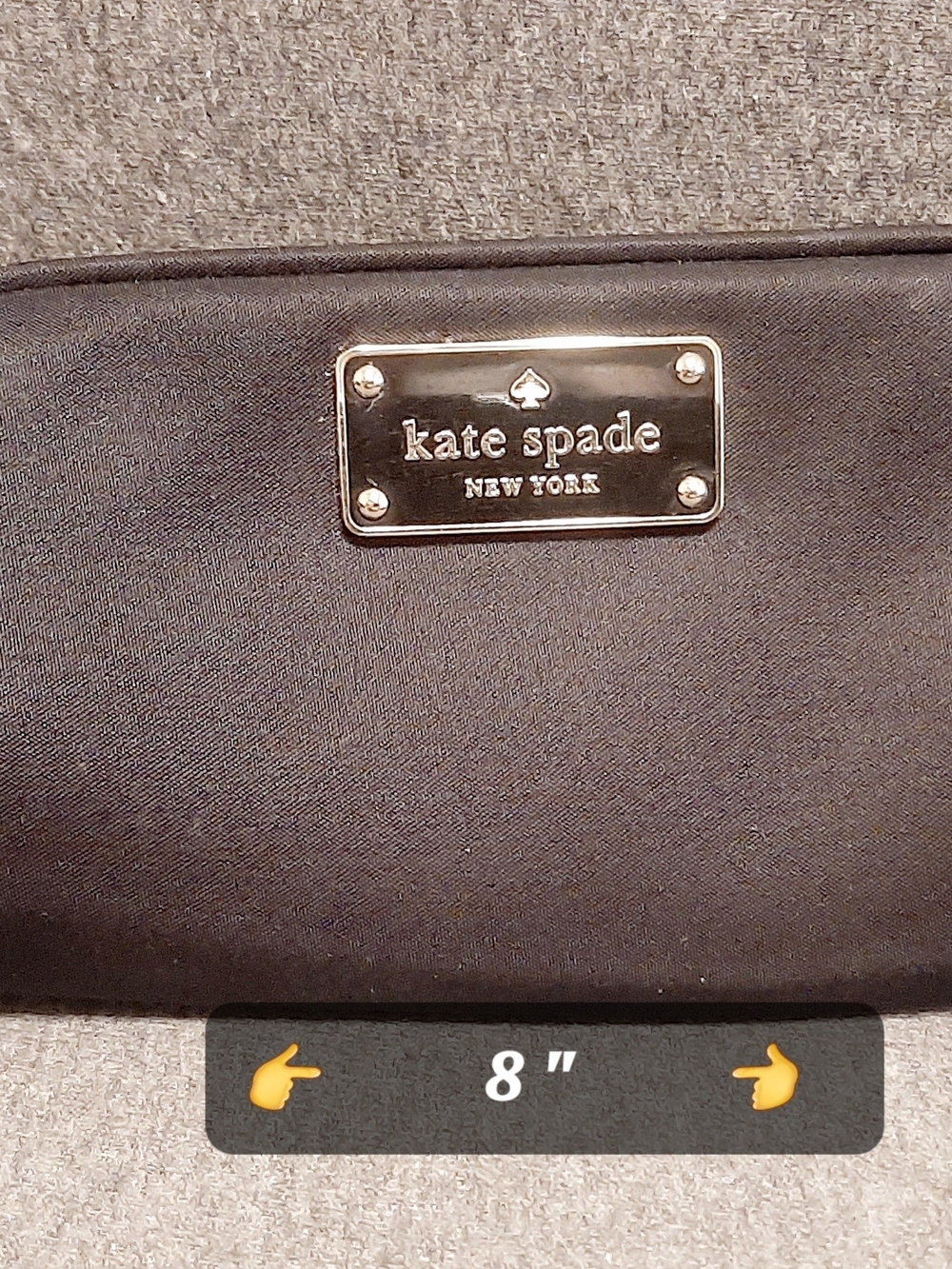 kate spade black clutch with metal logo plaque